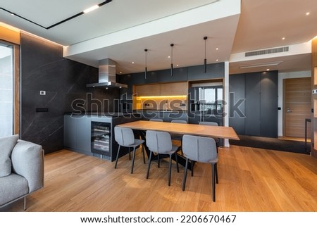 Luxury kitchen and dining room interior with brown parquet floor Royalty-Free Stock Photo #2206670467