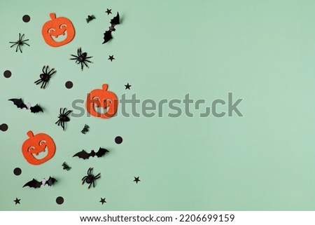 Halloween background with silhouettes of bats, spiders and pumpkins. Flat lay, top view