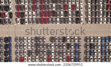 Aerial view of car storage or parking lot new unsold EV cars. Vehicle automaker and manufacturer parking facility. Low carbon footprint EV electric cars are ready for further distribution.  Royalty-Free Stock Photo #2206729951