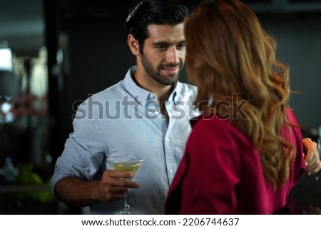 Man and woman flirting with each other in bar At Evening Party. Romantic couple dating at night in pub. couple dating , propose marriage. Romantic couple on a date sitting in a restaurant.  Royalty-Free Stock Photo #2206744637