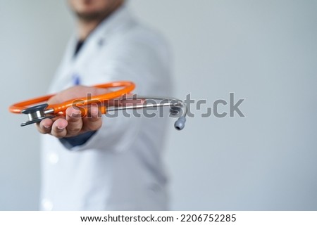 Quit medicine concept. Starting as a doctor concept. Doctor offering stethoscope in hand Royalty-Free Stock Photo #2206752285