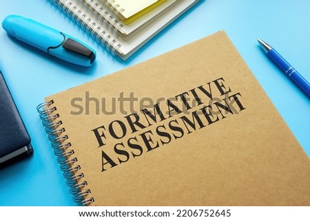 Formative Assessment guide and notebooks on the desk. Royalty-Free Stock Photo #2206752645