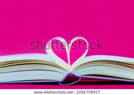 heart shaped book. Pages of a book curved into a heart shape. Opened book, pages shaped to form a heart	 Royalty-Free Stock Photo #2206758457