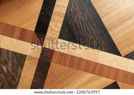 Vintage parquet with geometric pattern. Background photo texture, top view