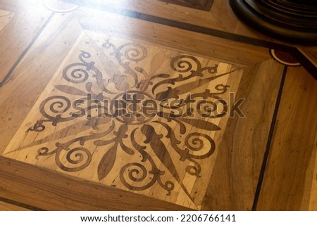 Vintage wooden parquet with floral inlay  pattern. Background photo texture Royalty-Free Stock Photo #2206766141