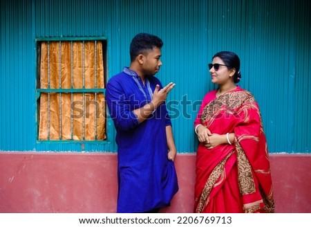 South asian hindu religious young married couple in outside the house 