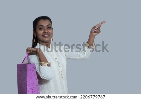 Portrait of a young girl holding shopping bag