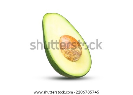 Half of fresh avocado with pit isolated on white background. Ripe fresh green avocado Clipping Path. Full Depth of field. Focus stacking

