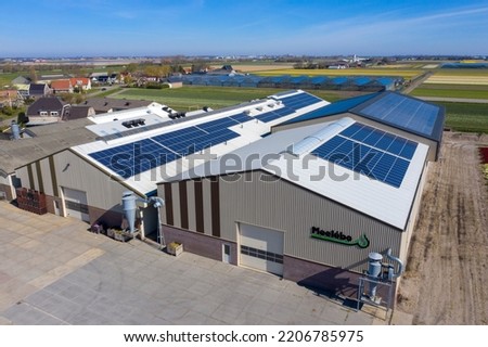 Drone photo of modern solar panels on a commercial building. Solar panels provide cheap solar energy.