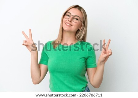 Young caucasian woman isolated on white background showing victory sign with both hands