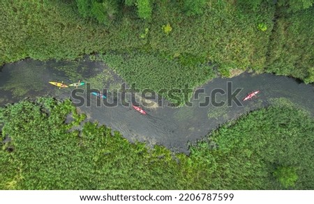 Natural river in the forest with peoples canoeing- aerial view Royalty-Free Stock Photo #2206787599