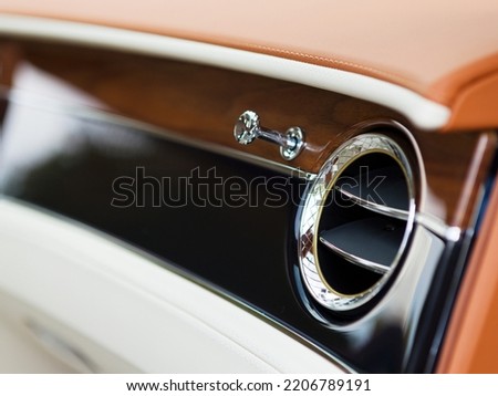 ventilation in a modern car with leather and wood trim