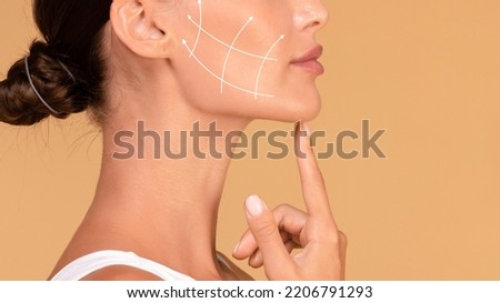 Profile of young woman with clean fresh skin, antiaging concept. Lady touching chin, lifting arrows showing facial anti-aging treatment on skin, panorama, free space