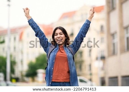 Portrait Of Happy Middle Eastern Female Student Celebrating Success Outdoors At Campus, Cheerful Young Arab Woman Raising Hands And Exclaiming With Excitement, Successfully Passed Exam, Copy Space
