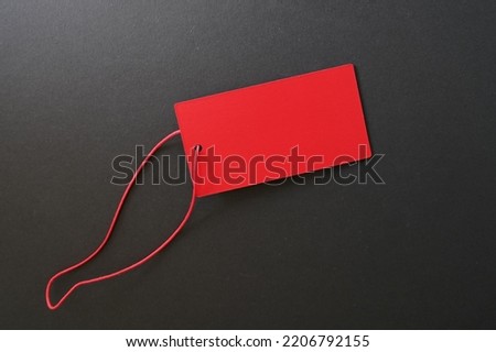 Red paper label tag with string