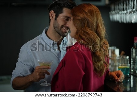 Man and woman flirting with each other in bar At Evening Party. Romantic couple dating at night in pub. couple dating , propose marriage. Romantic couple on a date sitting in a restaurant.  Royalty-Free Stock Photo #2206799743