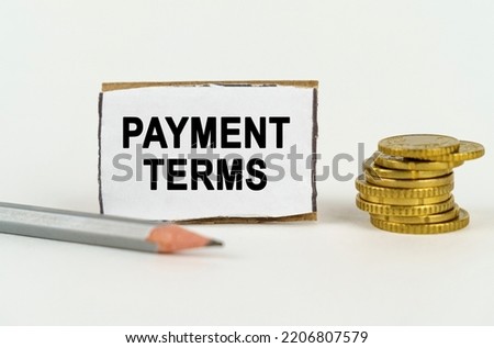 Business concept. On a white background, a pencil, coins and a sign with the inscription - Payment terms