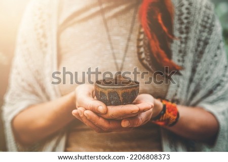 Cacao ceremony, heart opening medicine. Ceremony space. Cacao cup in woman's hand. Royalty-Free Stock Photo #2206808373