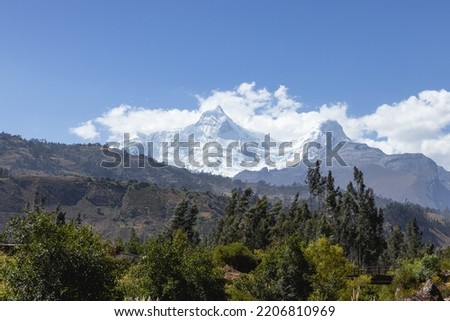 The summits of the snow-capped Huandoy (6 395 masl) with diverse vegetation at noon, belongs to the Cordillera Blanca. Taken from Ranrahirca, Yungay, Ancash - Peru, South America. Royalty-Free Stock Photo #2206810969