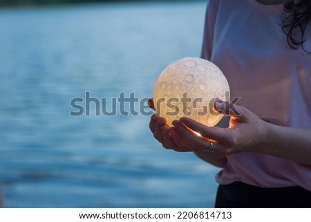 Close up moon in woman's hands. Astrology concept. Copy space Royalty-Free Stock Photo #2206814713