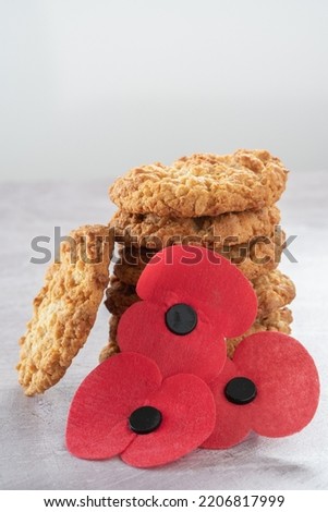 Stack of Anzac Biscuits with Poppies on a Table with Copy Space Vertical