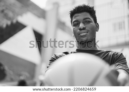 Young African player man looking at camera after basketball game - Focus on face - Black and white editing