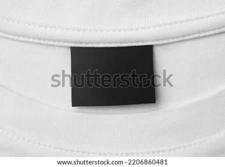 blank black color clothing label on white t shirt