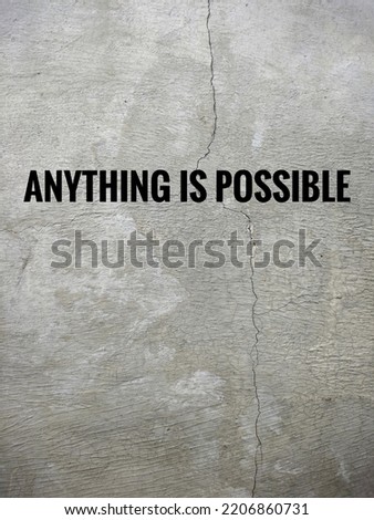Inspirational quote "Anything is possible" in concrete wall texture background