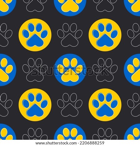 Paw of a cat or dog. Blue and yellow paws of animals on a black background. Cute seamless pattern. Vector.