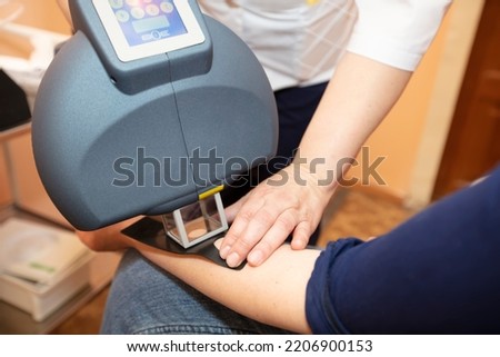 Phototherapy of skin diseases. Treatment of skin diseases such as vitiligo, psoriasis and eczema with a special medical device. Royalty-Free Stock Photo #2206900153