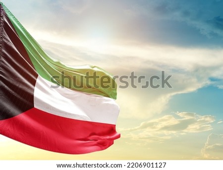 Kuwait national flag waving in beautiful sky.