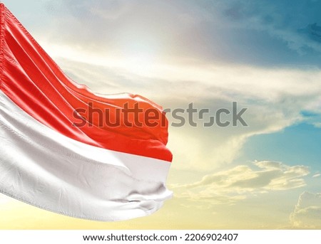 Indonesia national flag waving in beautiful sky.