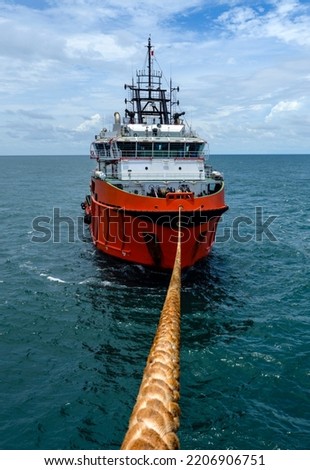Towed vessel in the high sea Royalty-Free Stock Photo #2206906751