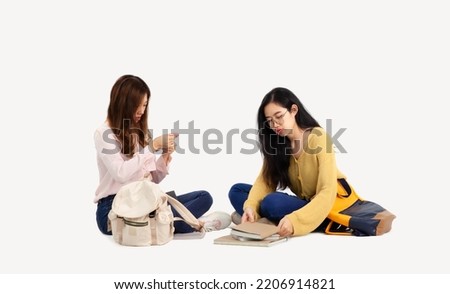 Young asian college women long hair in casual sitting on white background.