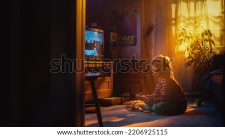 Young Girl Playing Eighties Eight Bit Arcade Video Game on a Console at Home in Her Room with Old-School Interior. Child Successfully Wins Hardest Level. Nostalgic Retro Childhood Concept.