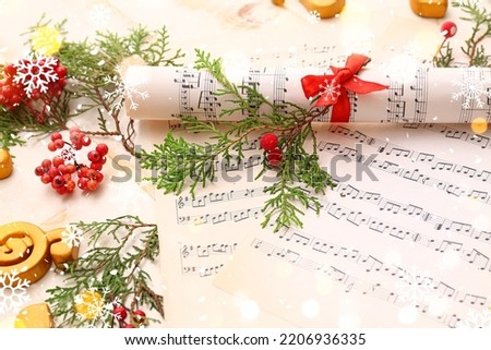 Christmas composition with music note sheets, closeup