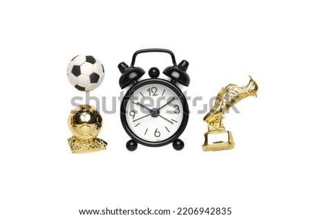 A flatlay picture of alarm clock, ball, golden ball and golden boot on white background. Time for football match