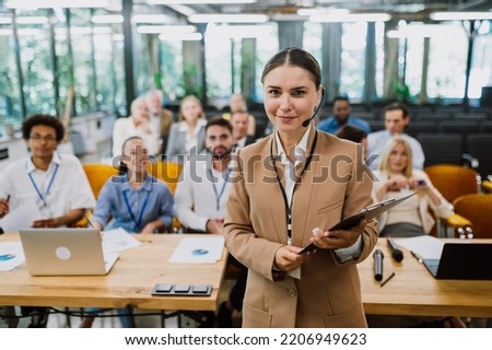 Cinematic image of a conference meeting. Business people sitting in a room listening to the motivator coach. Representation of a Self growth and improvement special event Royalty-Free Stock Photo #2206949623