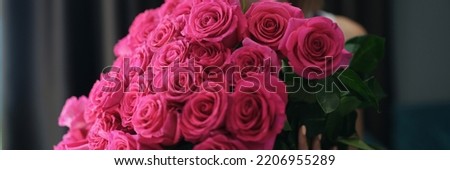 Attractive young female hold bouquet of pink flowers on birthday or anniversary Royalty-Free Stock Photo #2206955289