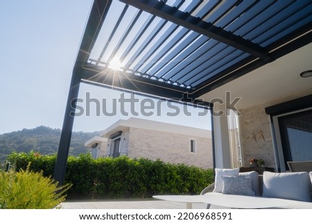 Pergola awning in the sunshine photo Royalty-Free Stock Photo #2206968591