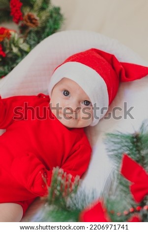 Baby in a cocoon new year . An article about the new year. An article about children. The first new year of the baby. Red bodysuit. Copy Space