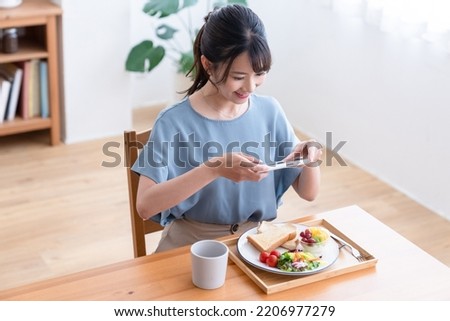 woman taking picture of breakfast
