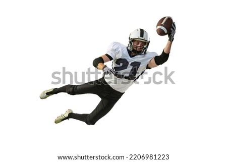 American football player in motion, catching ball in a jump isolated over white background. Dynamics and motion. Concept of active life, team game, energy, sport, competition. Copy space for ad