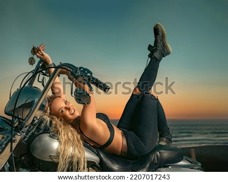 Beautiful girl on a motorcycle. Woman on american chopper. Cover for a music album or sound track