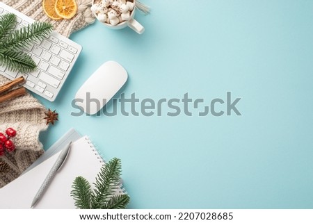 Top view photo of keyboard computer mouse notebook plaid cup of cocoa with marshmallow fir branches mistletoe cinnamon sticks and dried orange slices on isolated pastel blue background with copyspace