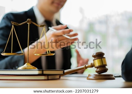 Legal services concepts at the Computer Labor Law Advising Office. lawyer working at the desk Hammer and scales on lawyer's table for justice Royalty-Free Stock Photo #2207031279