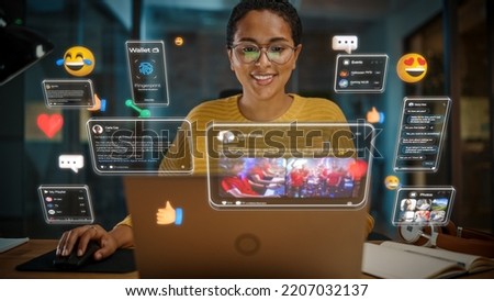 Beautiful Short Haired Project Manager Working on Computer in Office. Augmented Reality Social Media Icons Appear From Worker's Laptop. Internet of Things, Internet Connectivity and Online Concept. Royalty-Free Stock Photo #2207032137