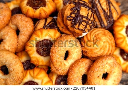 Fresh homemade biscuits in stock. Sweet cookies on a wooden table. Dessert sweet biscuits for tea and coffee. Concept of yummy, cookies, desserts.