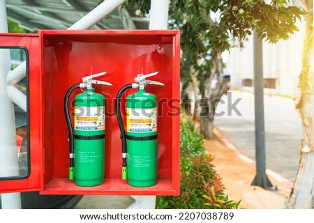 Fire Extinguisher in red cabinet at exterior buildings.