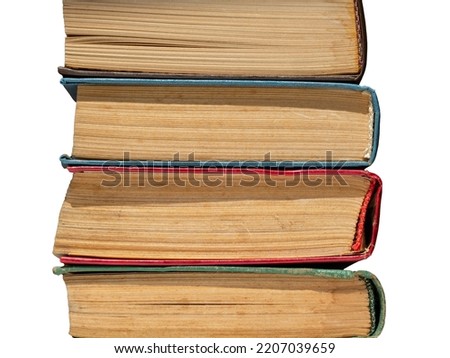 A stack of old yellowed hardcover books isolated on a white background